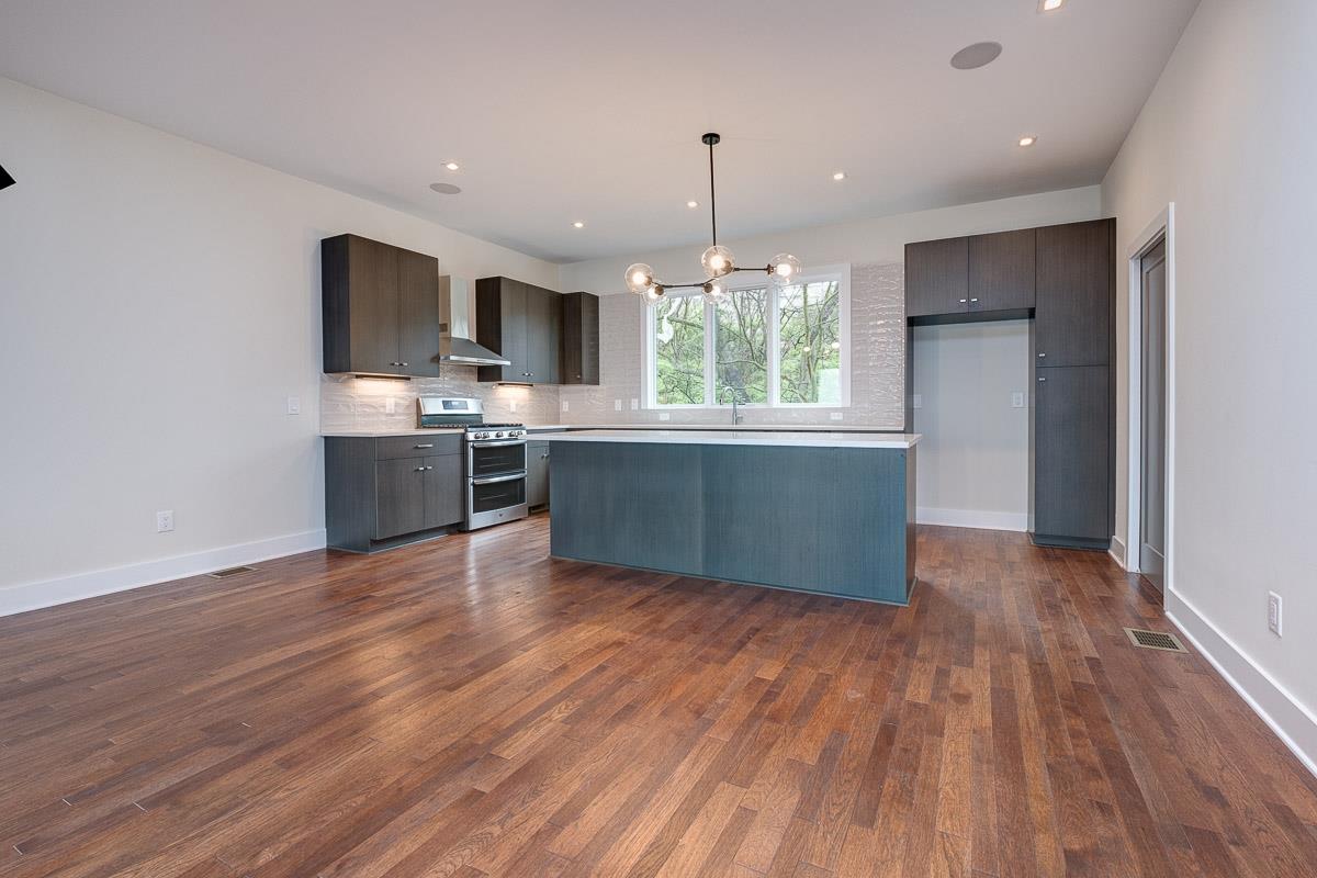 2106 9th Avenue North, Unit 3 Nashville, TN 37228 - Photo 5 of 30 a room with wooden floors and kitchen view