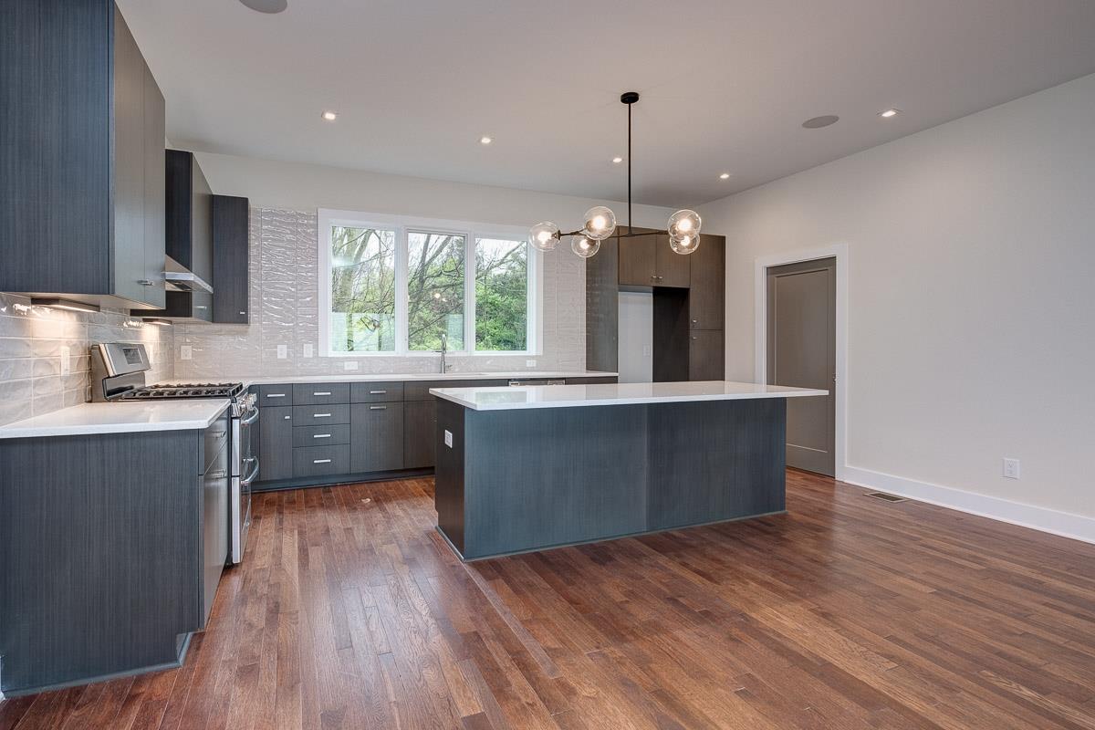 2106 9th Avenue North, Unit 3 Nashville, TN 37228 - Photo 6 of 30 a kitchen with stainless steel appliances granite countertop wooden floors sink and window