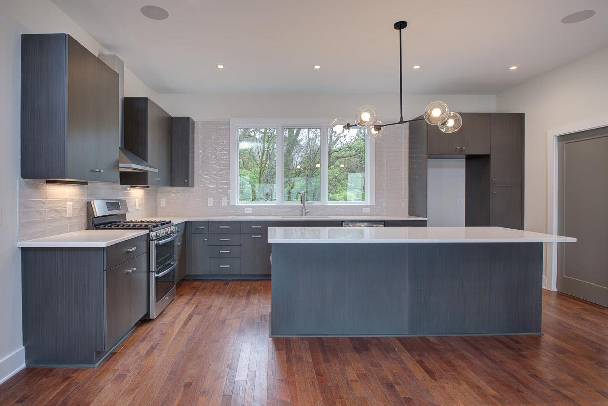 2106 9th Avenue North, Unit 3 Nashville, TN 37228 - Photo 7 of 30 a large kitchen with lots of counter space a sink appliances and cabinets