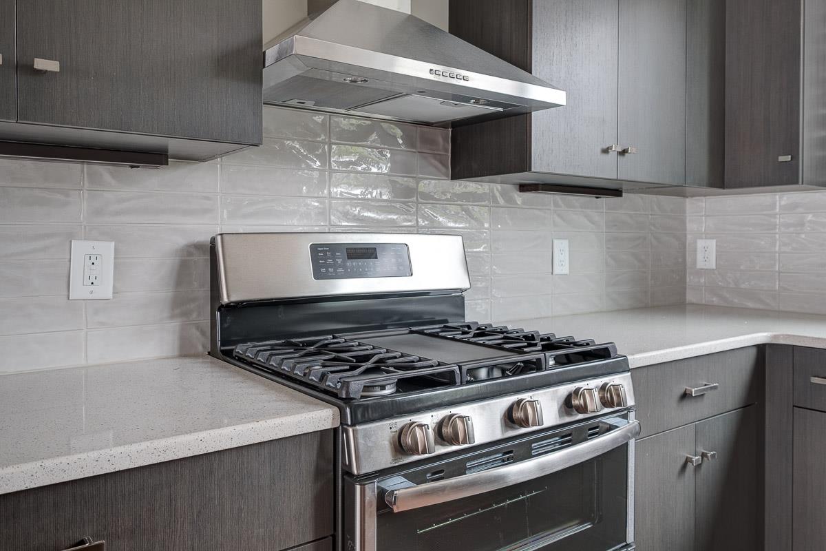 2106 9th Avenue North, Unit 3 Nashville, TN 37228 - Photo 10 of 30 a kitchen with stainless steel appliances granite countertop a stove and a microwave