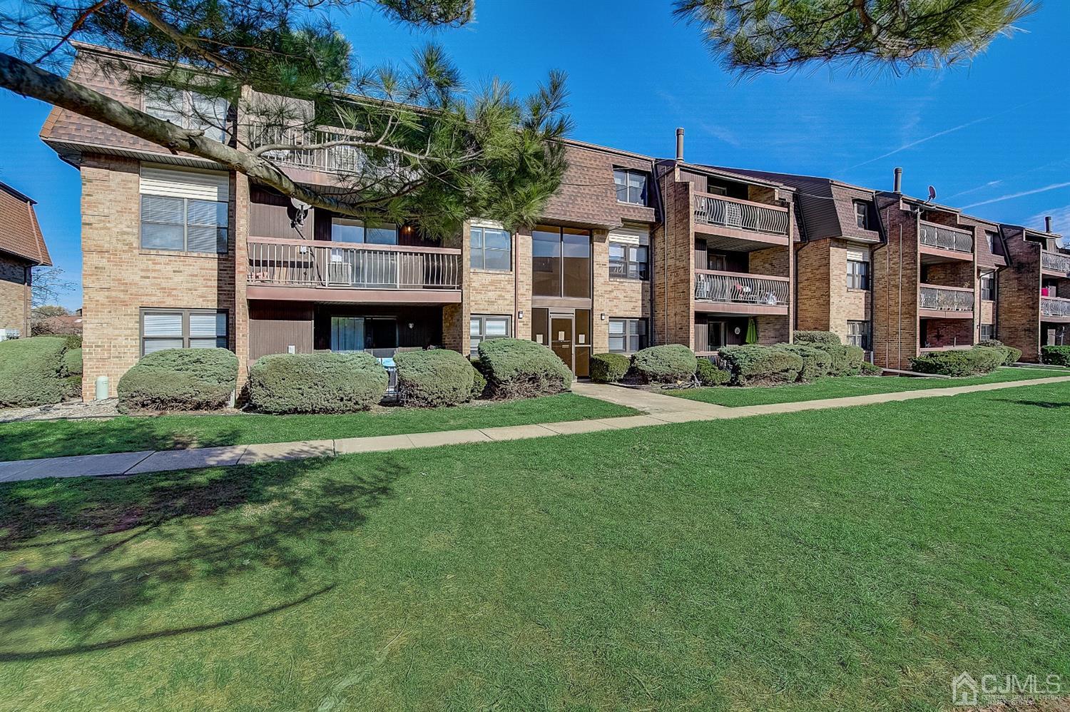 1508 Raspberry Court Edison, NJ 08817 - Photo 18 of 20 a front view of a building with garden and trees