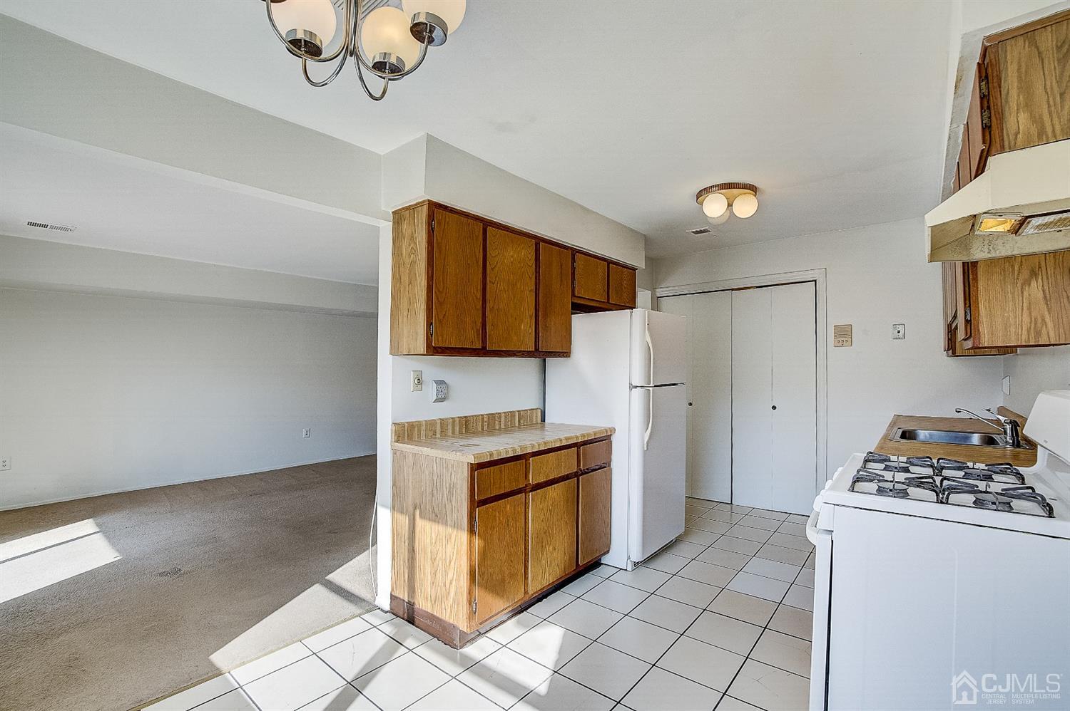 1508 Raspberry Court Edison, NJ 08817 - Photo 6 of 20 a kitchen with a stove cabinets and a refrigerator