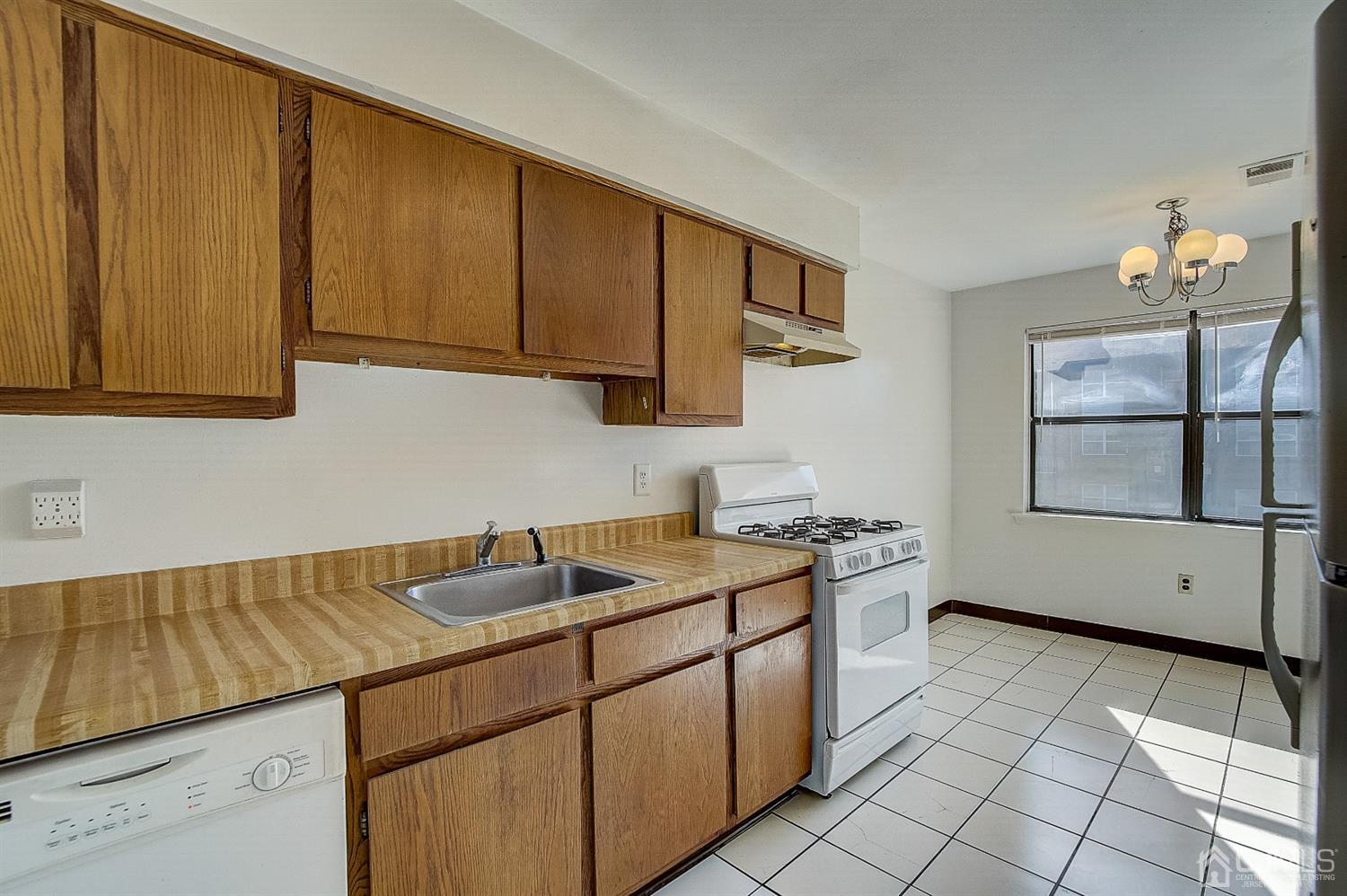 1508 Raspberry Court Edison, NJ 08817 - Photo 7 of 20 a kitchen with stainless steel appliances granite countertop a sink stove and cabinets