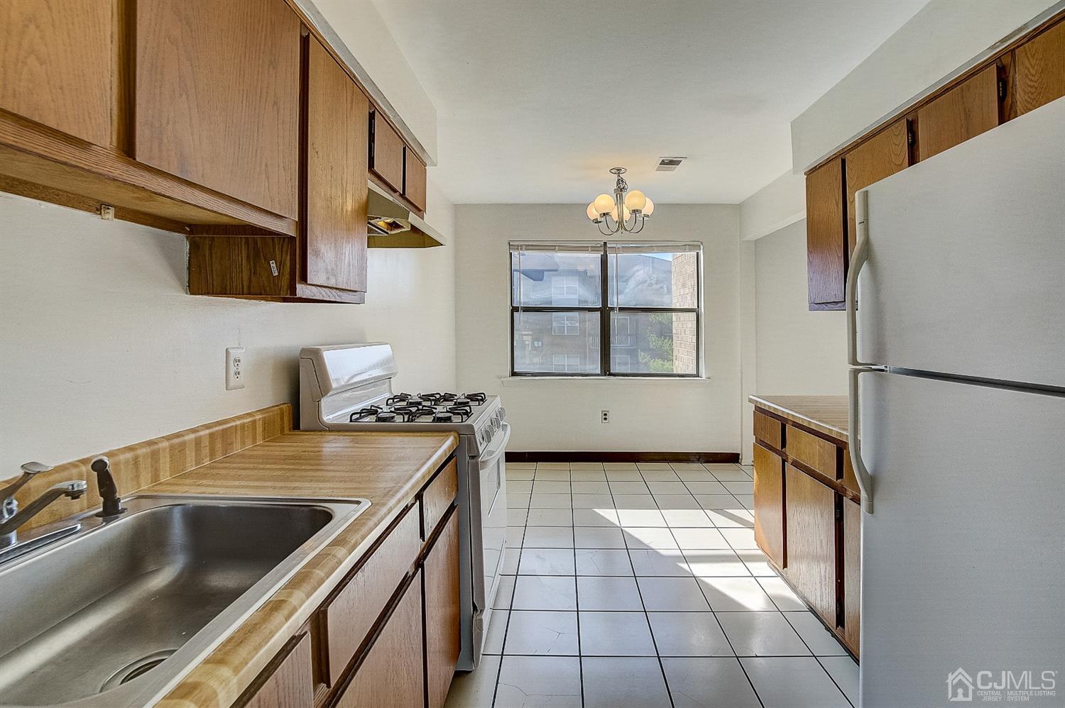 1508 Raspberry Court Edison, NJ 08817 - Photo 8 of 20 a kitchen with a refrigerator a stove and a sink