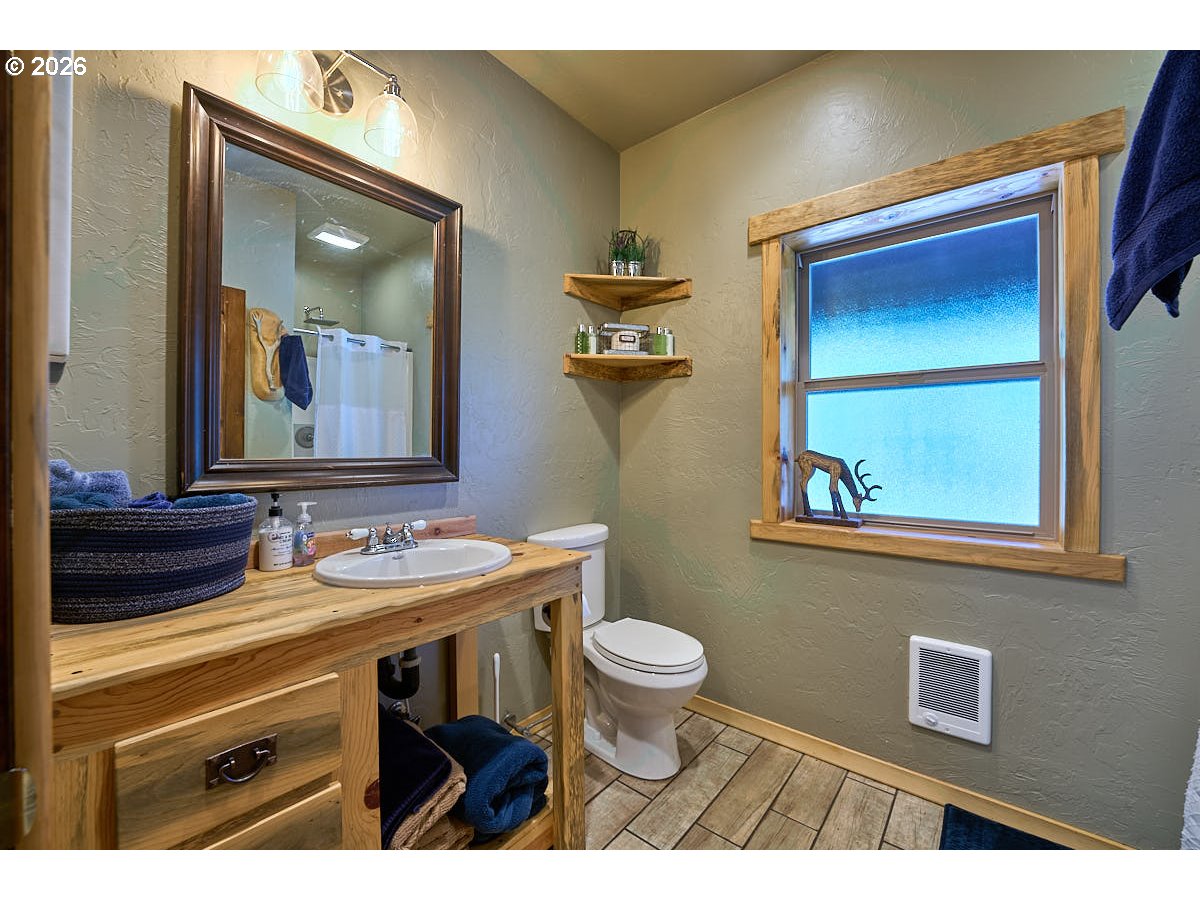 61718 Chief Joseph Loop Road Joseph, OR 97846 - Photo 12 of 38 a bathroom with a toilet a sink and mirror