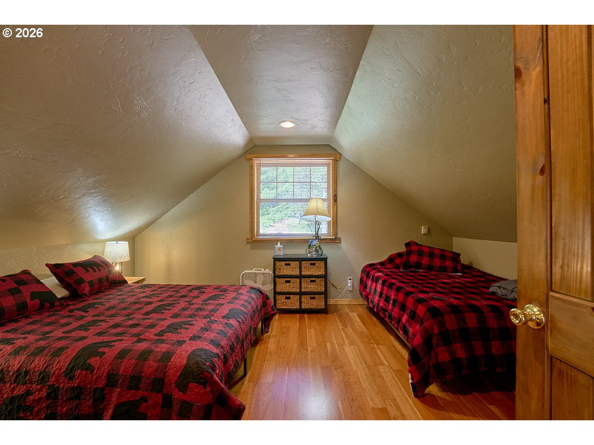 61718 Chief Joseph Loop Road Joseph, OR 97846 - Photo 16 of 38 a bedroom with a bed and a lamp