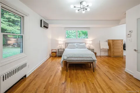 a living room with a bed furniture and a window