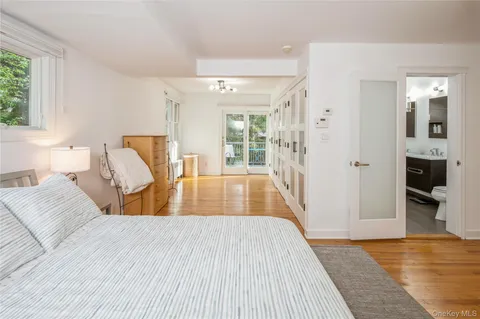 a bedroom with wooden floor and a large bed