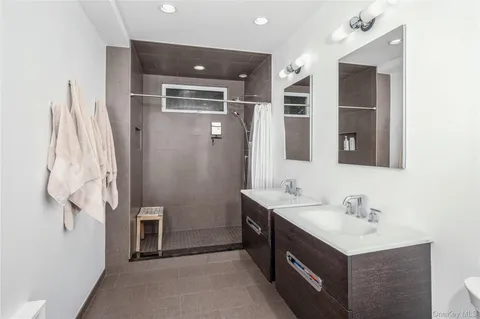 a bathroom with a sink vanity and a mirror