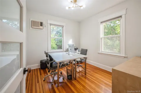 a view of a dining room with furniture window and wooden floor