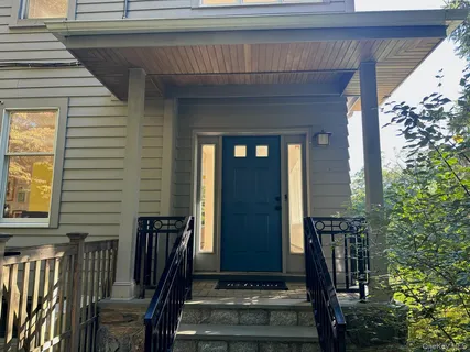 a front view of a house having outdoor seating