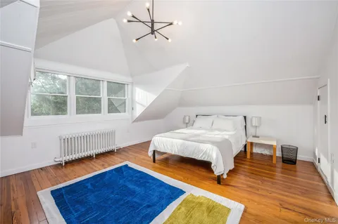 a spacious bedroom with a bed and a window