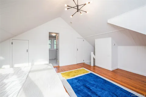 a view of room with wooden floor and ceiling fan