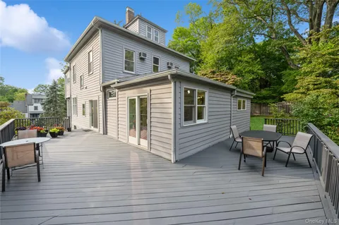 a view of a house with backyard and sitting area