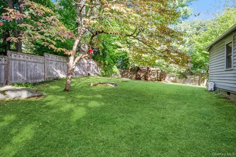 a view of a backyard with a tree