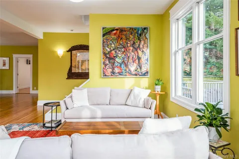 a living room with couch and a potted plant