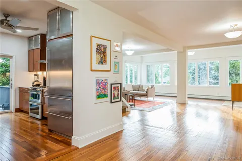 a kitchen with granite countertop stainless steel appliances a stove and a refrigerator