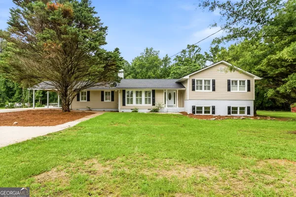 a front view of a house with a garden