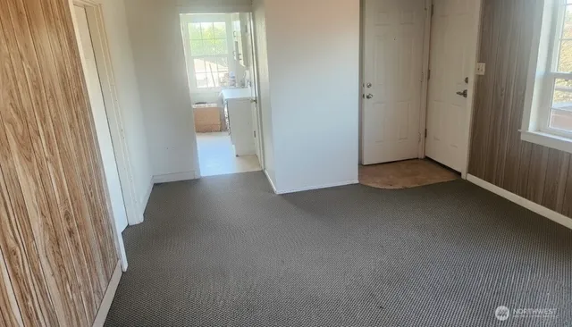 a view of a room with a wooden door