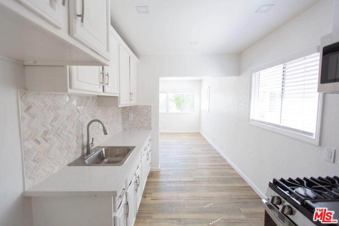 5267 Ithaca Avenue Los Angeles, CA 90032 - Photo 11 of 25 a kitchen with sink a stove and cabinets