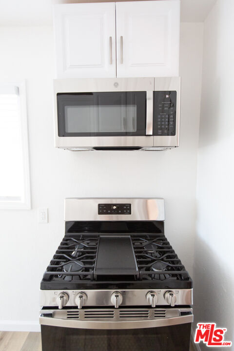5267 Ithaca Avenue Los Angeles, CA 90032 - Photo 12 of 25 a stove top oven sitting inside of a kitchen