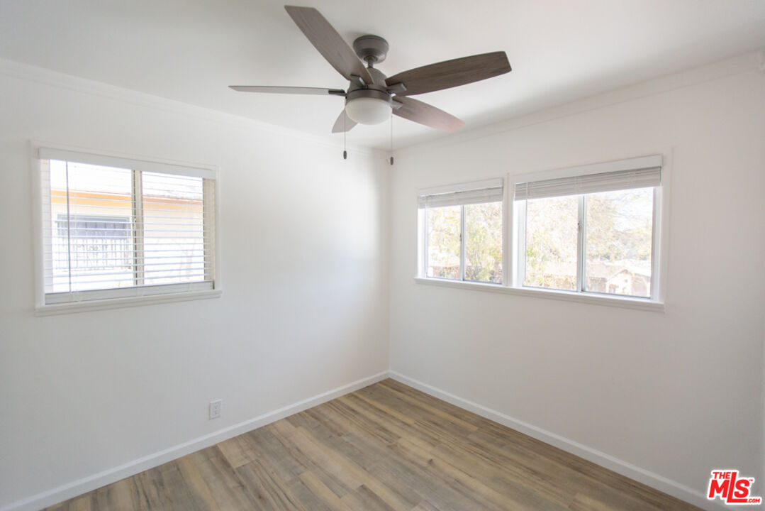 5267 Ithaca Avenue Los Angeles, CA 90032 - Photo 13 of 25 an empty room with a window and a ceiling fan