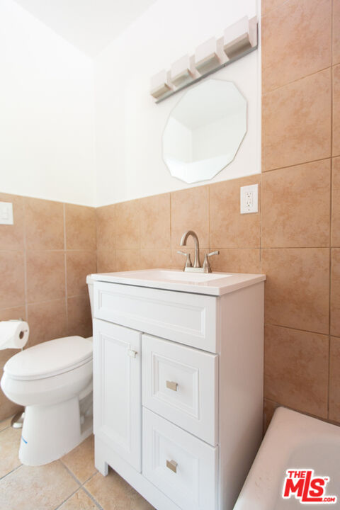 5267 Ithaca Avenue Los Angeles, CA 90032 - Photo 17 of 25 a bathroom with a sink mirror and toilet