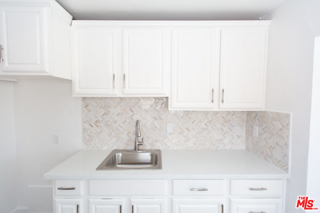 5267 Ithaca Avenue Los Angeles, CA 90032 - Photo 10 of 25 a kitchen with a sink and cabinets