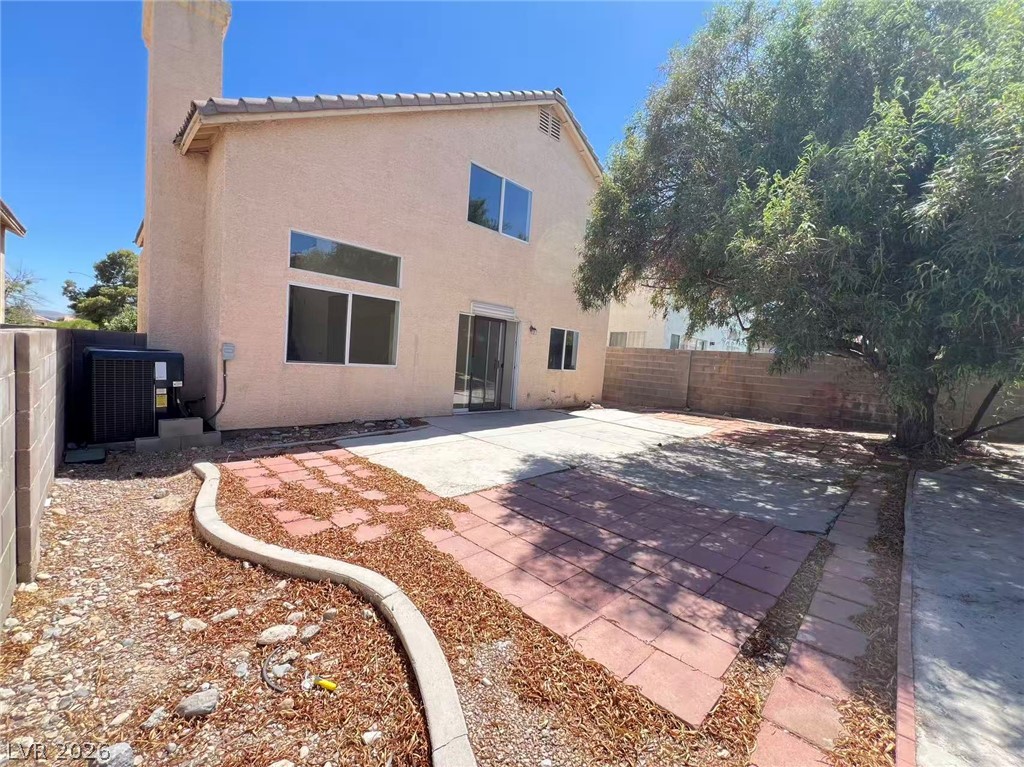 8284 West Rochelle Avenue Las Vegas, NV 89147 - Photo 29 of 29 A spacious backyard with a mix of paved and unpaved areas provides ample outdoor living space.