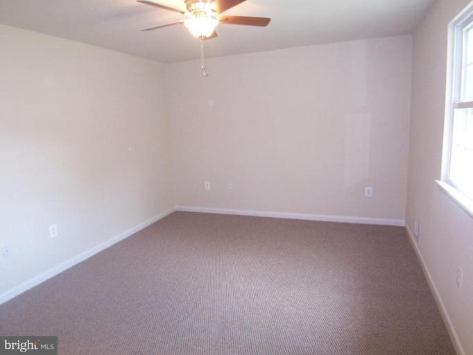 7909 Hart Road Fort Washington, MD 20744 - Photo 3 of 21 an empty room with a window and a fan