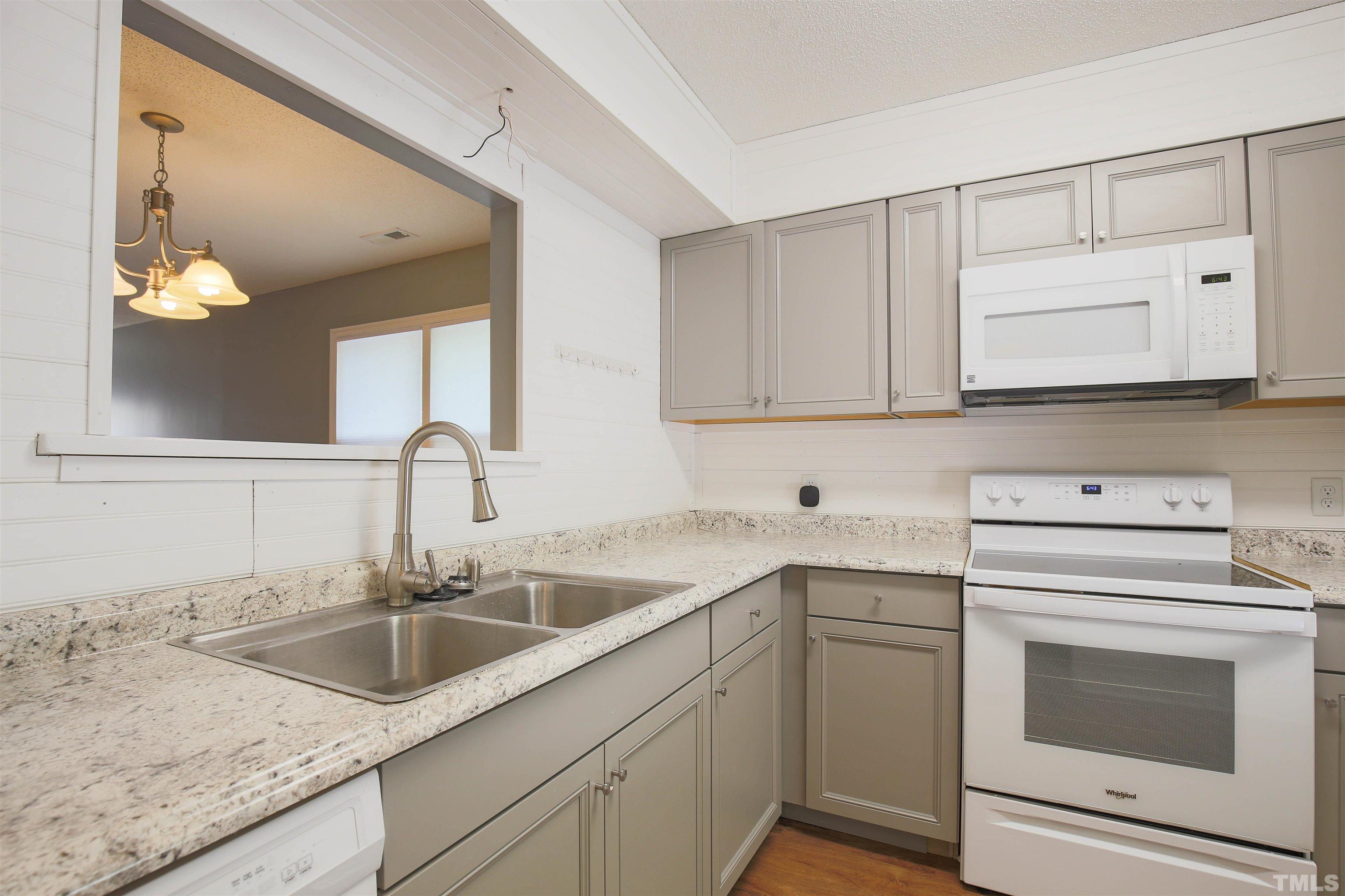 1507 Clermont Road, Unit T23 Durham, NC 27713 - Photo 14 of 24 a kitchen with cabinets appliances a sink and a counter top space