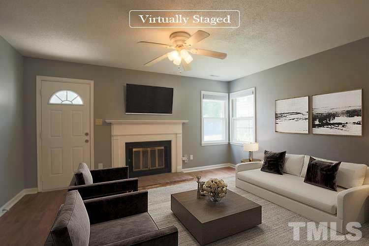 1507 Clermont Road, Unit T23 Durham, NC 27713 - Photo 2 of 24 a living room with furniture a fireplace and a flat screen tv