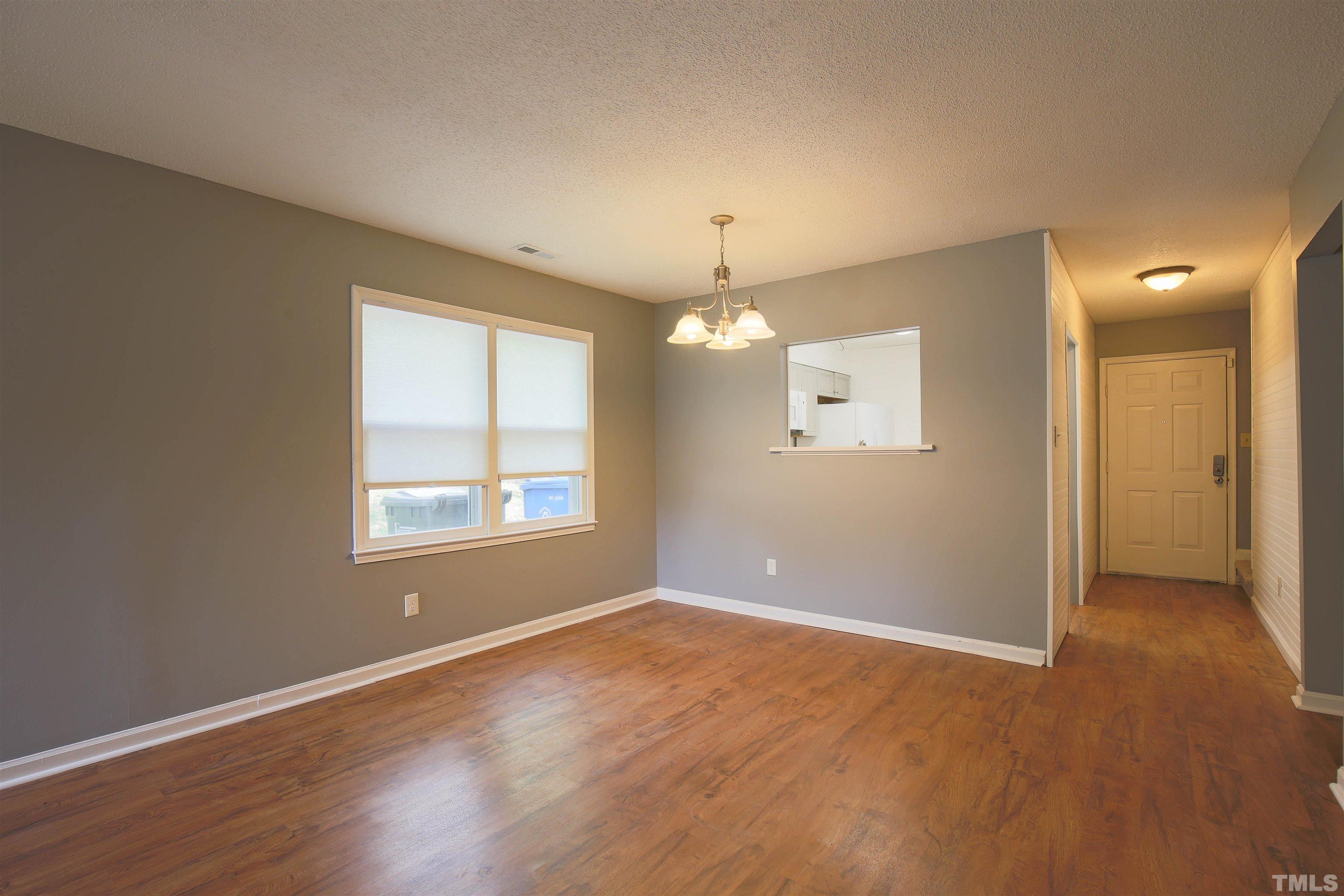 1507 Clermont Road, Unit T23 Durham, NC 27713 - Photo 5 of 24 an empty room with chandelier fan and windows