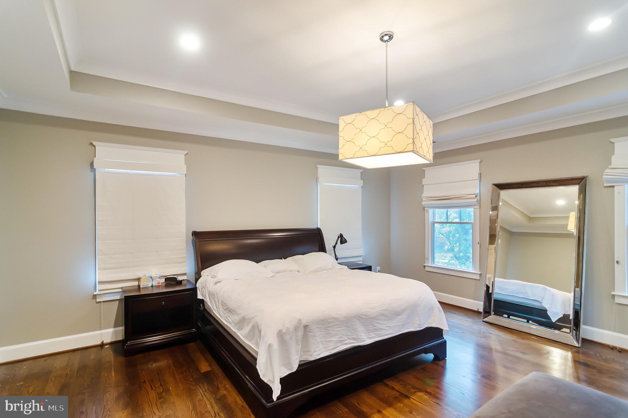 6801 Danforth Street McLean, VA 22101 - Photo 15 of 29 a bedroom with a bed and a chandelier