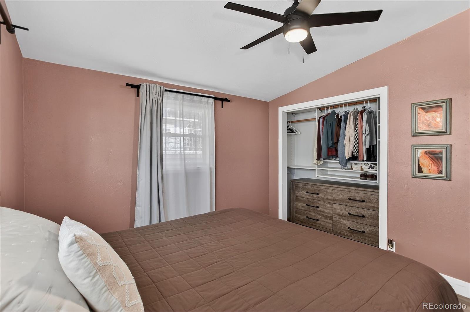 490 Quentin Street Aurora, CO 80011 - Photo 16 of 38 a bedroom with a bed and a dresser