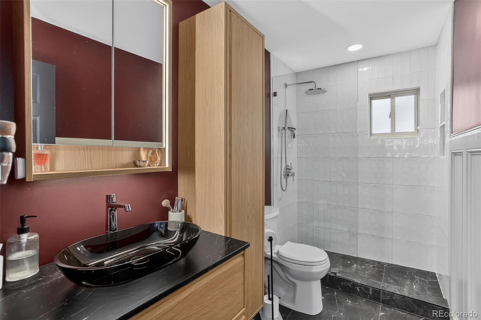 490 Quentin Street Aurora, CO 80011 - Photo 19 of 38 a bathroom with a granite countertop sink a toilet and shower