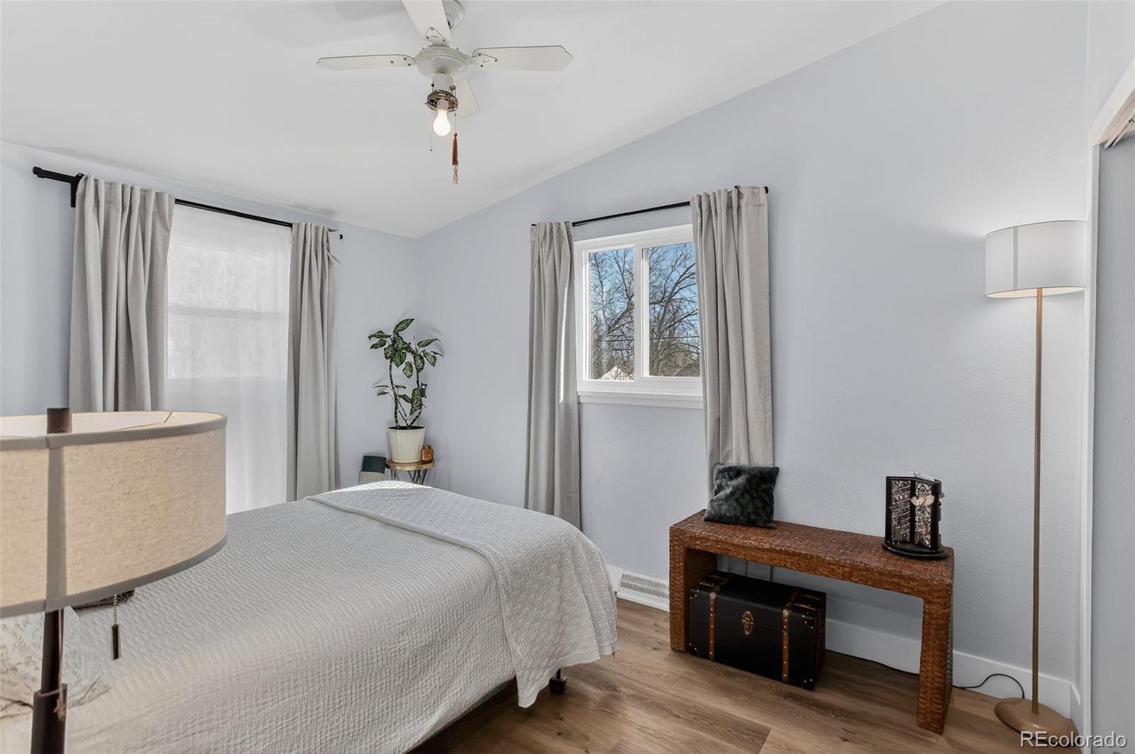 490 Quentin Street Aurora, CO 80011 - Photo 20 of 38 a bedroom with a bed and a table
