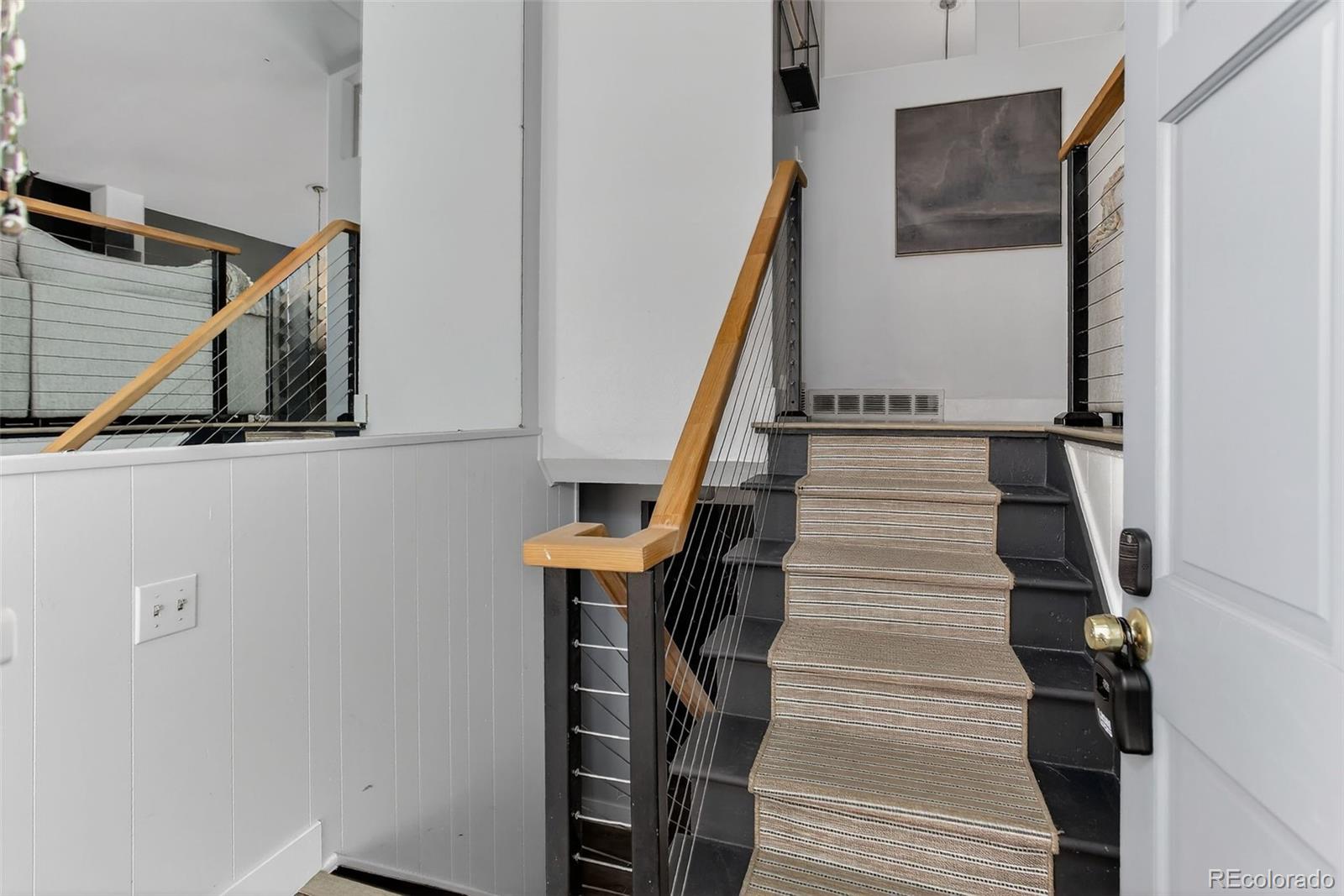 490 Quentin Street Aurora, CO 80011 - Photo 23 of 38 a view of entryway and hall with wooden floor