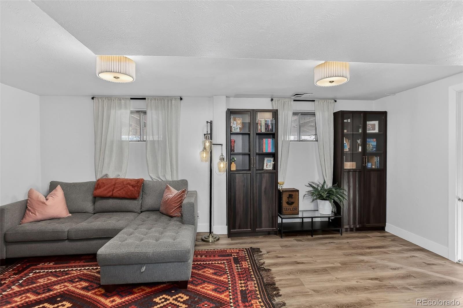 490 Quentin Street Aurora, CO 80011 - Photo 24 of 38 a living room with furniture and a couch