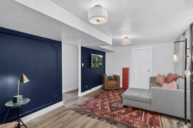 a living room with furniture and wooden floor