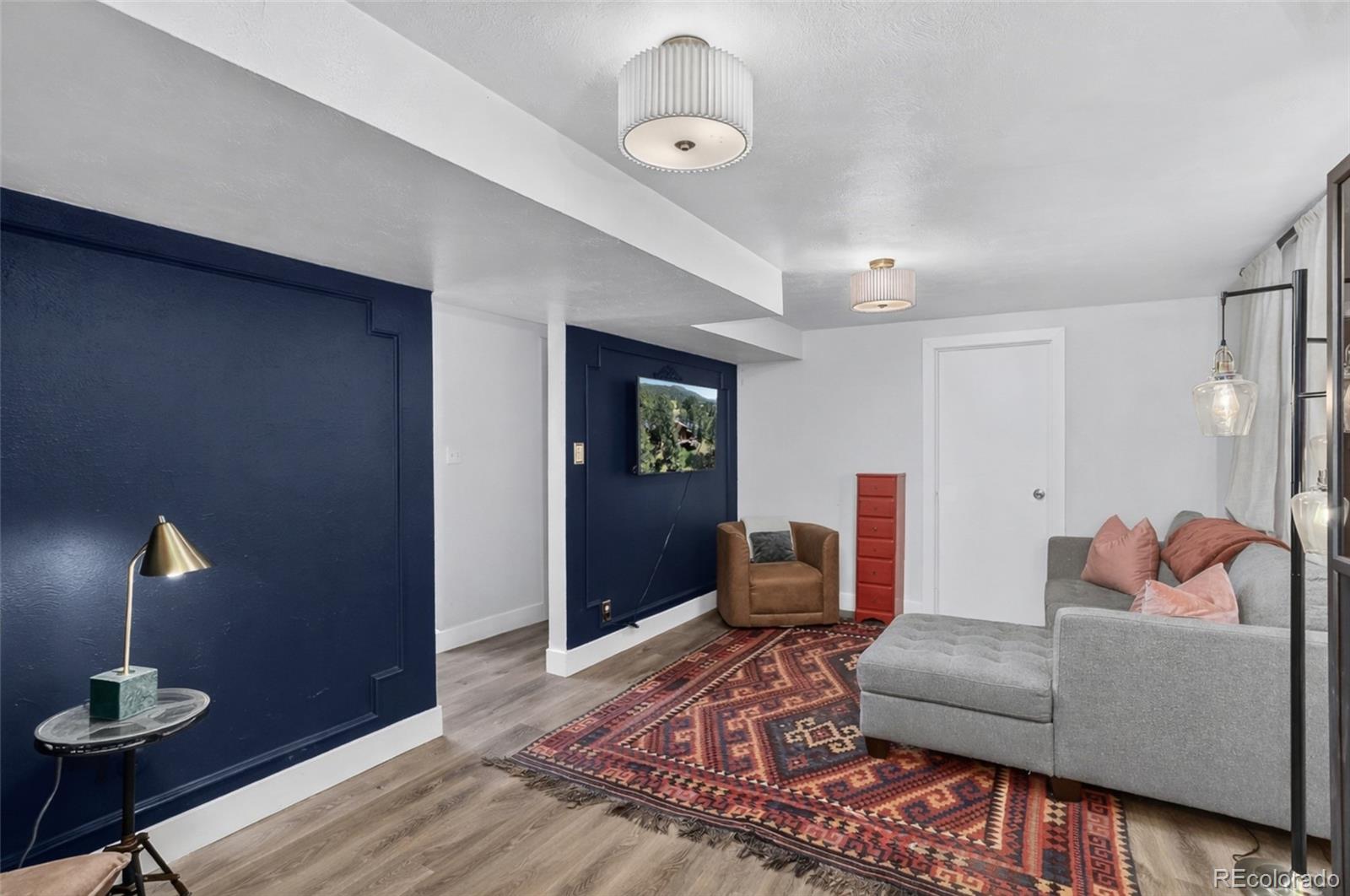 490 Quentin Street Aurora, CO 80011 - Photo 25 of 38 a living room with furniture and wooden floor