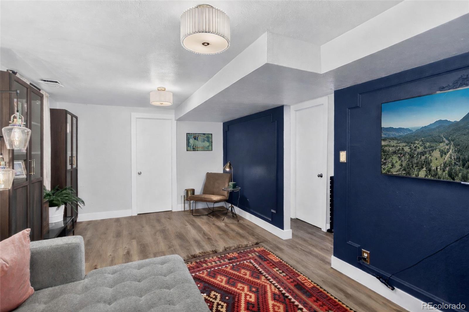 490 Quentin Street Aurora, CO 80011 - Photo 26 of 38 a living room with furniture and a flat screen tv