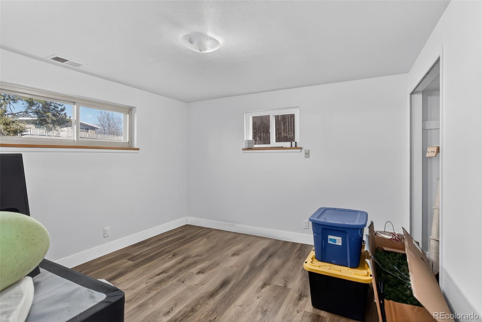 490 Quentin Street Aurora, CO 80011 - Photo 30 of 38 a view of a livingroom with furniture and wooden floor
