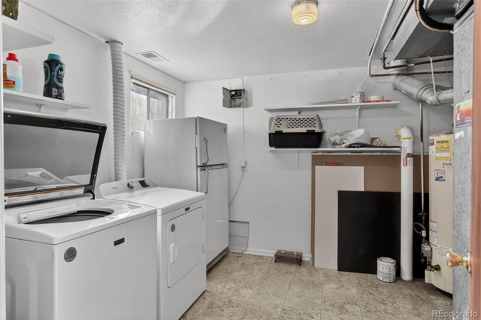 490 Quentin Street Aurora, CO 80011 - Photo 32 of 38 a kitchen with stainless steel appliances granite countertop a refrigerator a stove and a sink with wooden floor