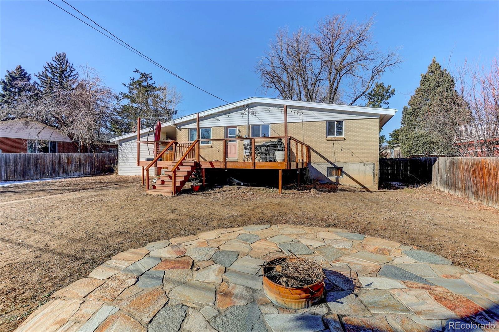490 Quentin Street Aurora, CO 80011 - Photo 35 of 38 a front view of a house with a yard and garage