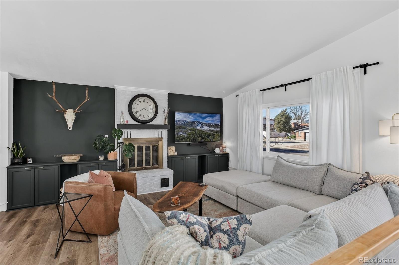 490 Quentin Street Aurora, CO 80011 - Photo 5 of 38 a living room with furniture a rug and wooden floor