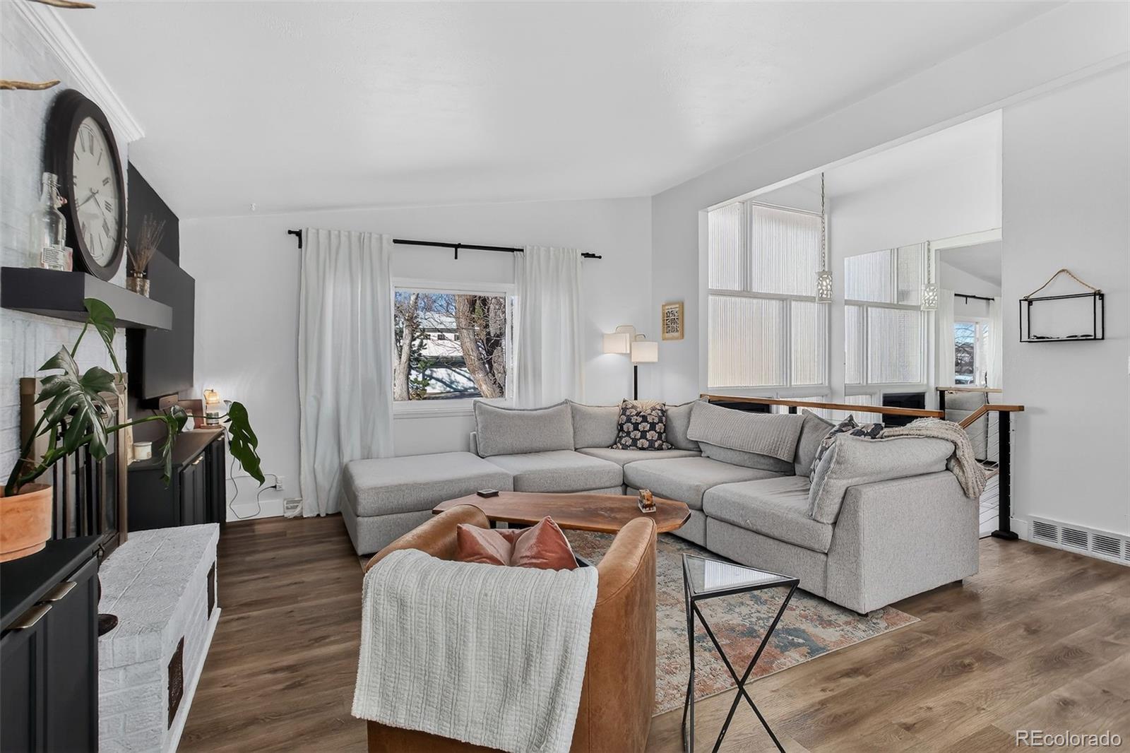 490 Quentin Street Aurora, CO 80011 - Photo 6 of 38 a living room with furniture a lamp and a window