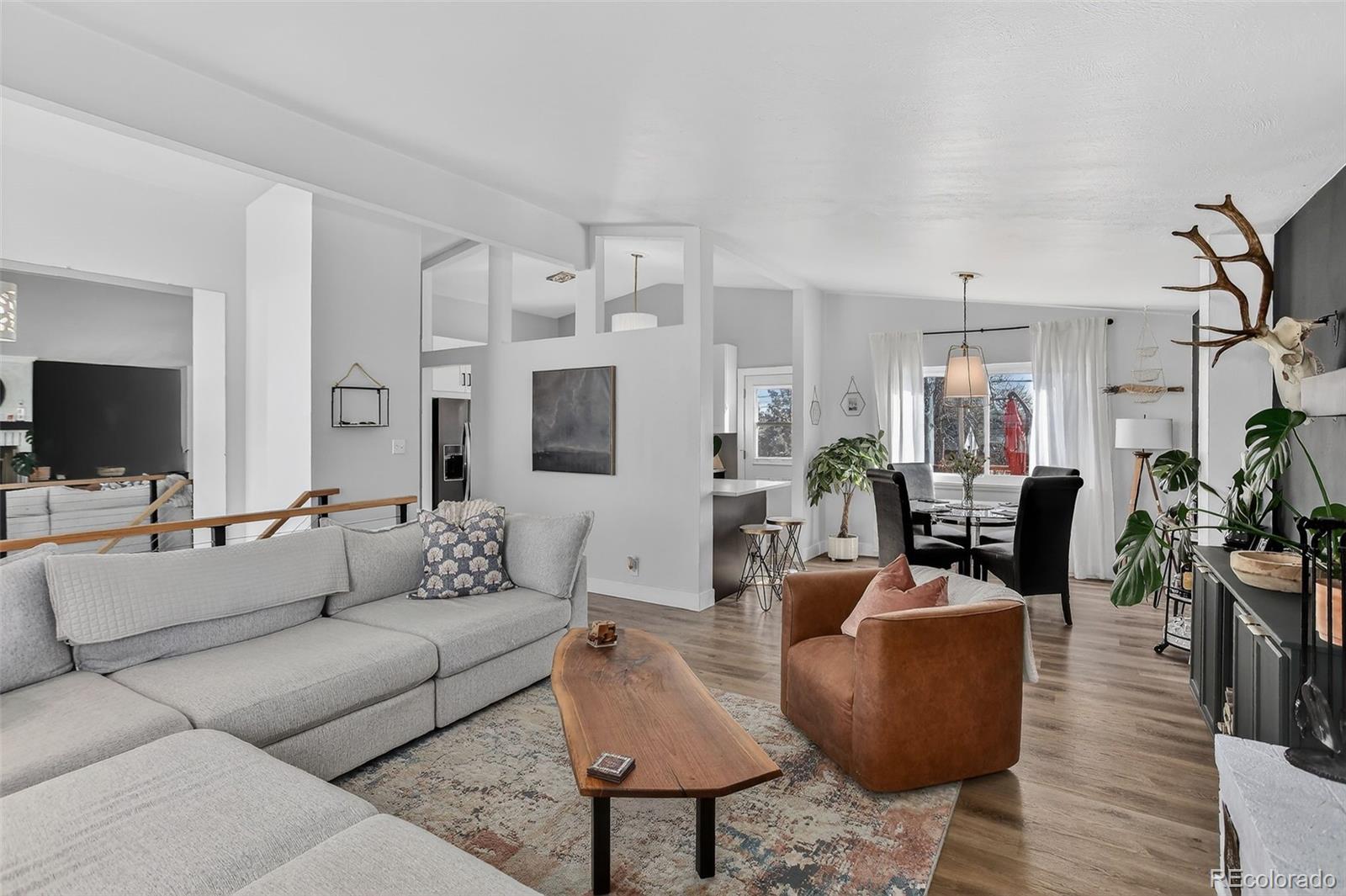 490 Quentin Street Aurora, CO 80011 - Photo 7 of 38 a living room with furniture and a flat screen tv
