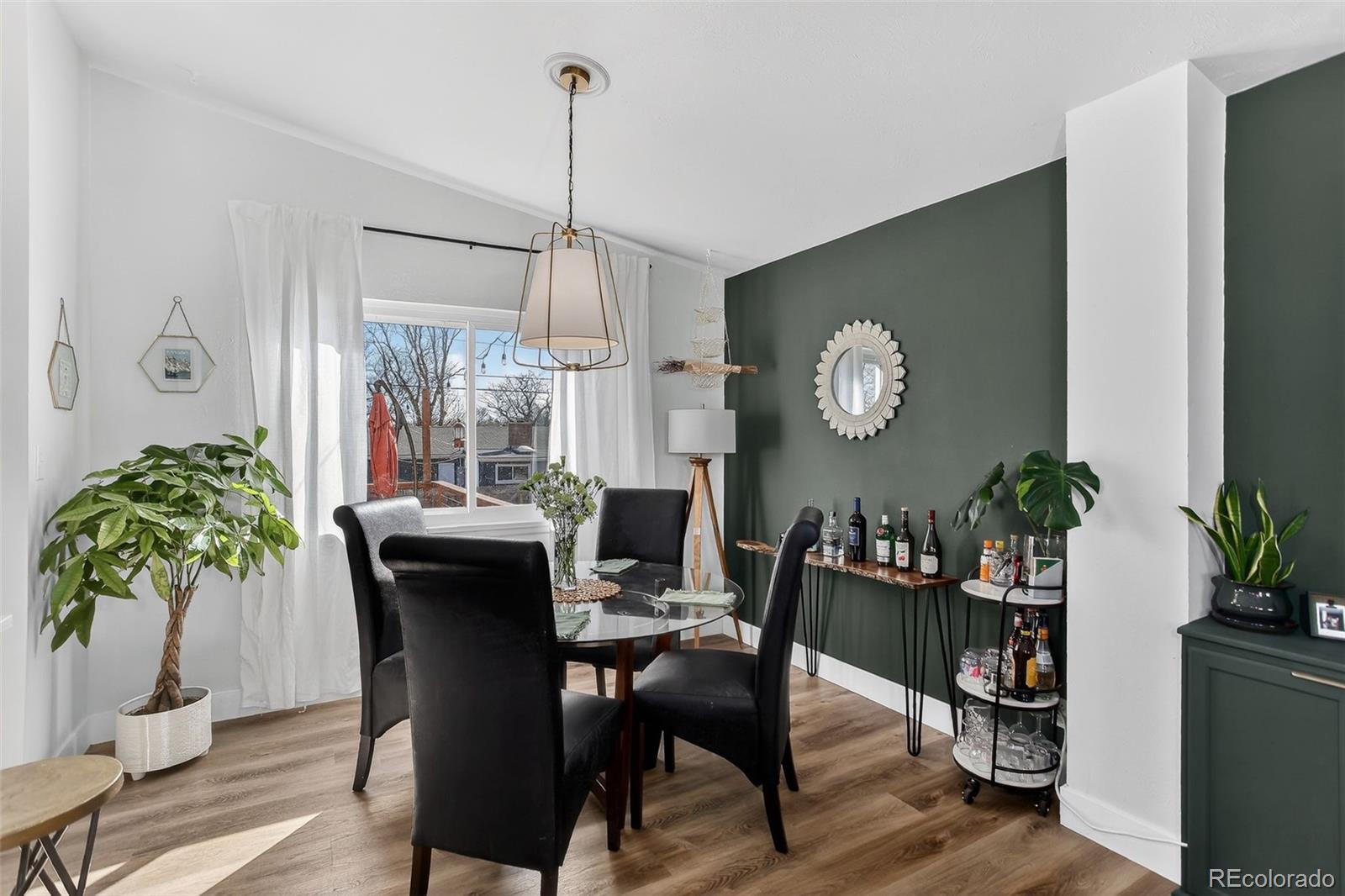 490 Quentin Street Aurora, CO 80011 - Photo 8 of 38 a view of a dining room with furniture window and wooden floor