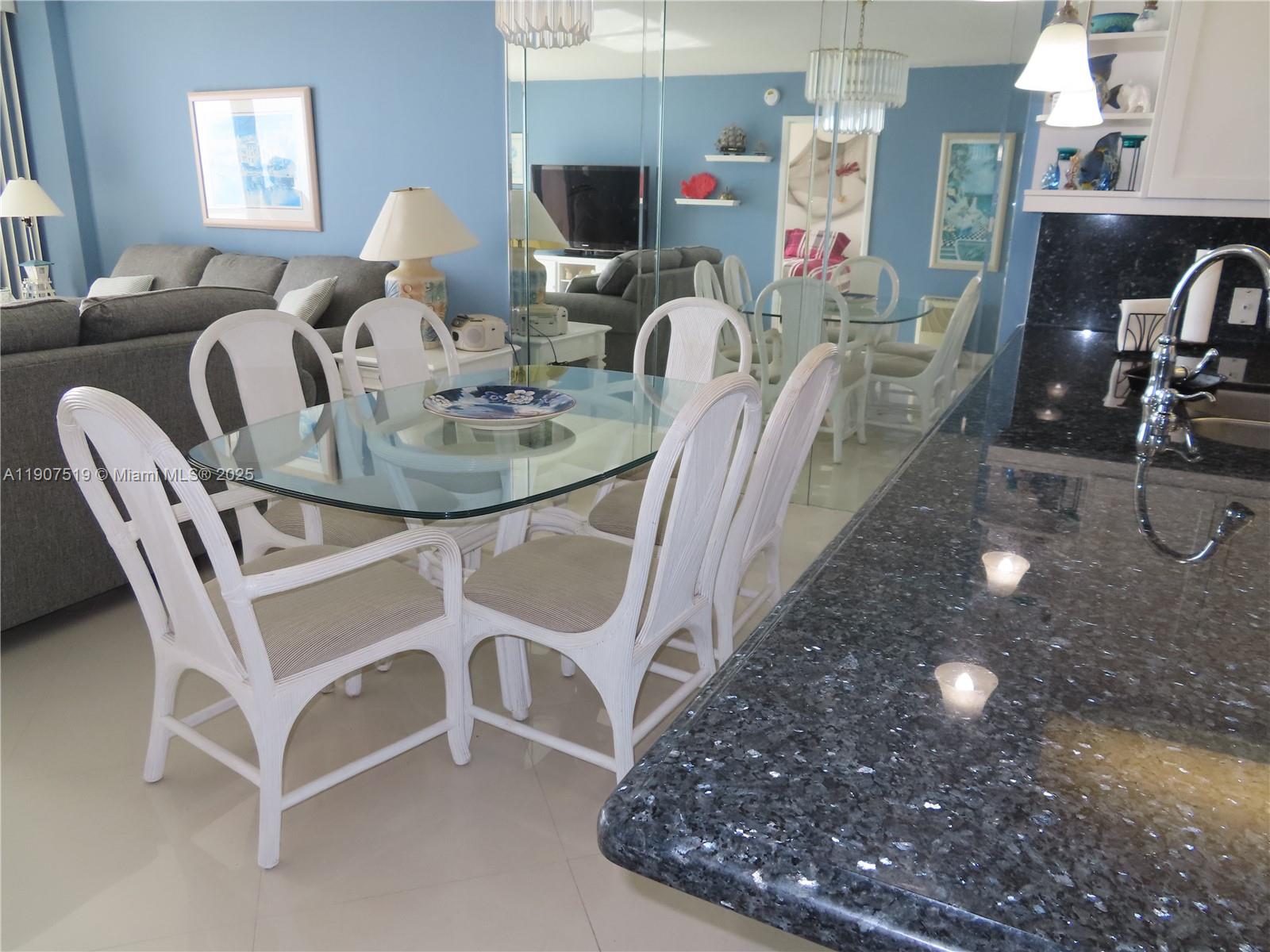 5701 Collins Avenue, Unit 304 Miami Beach, FL 33140 - Photo 11 of 42 a view of a dining room with furniture